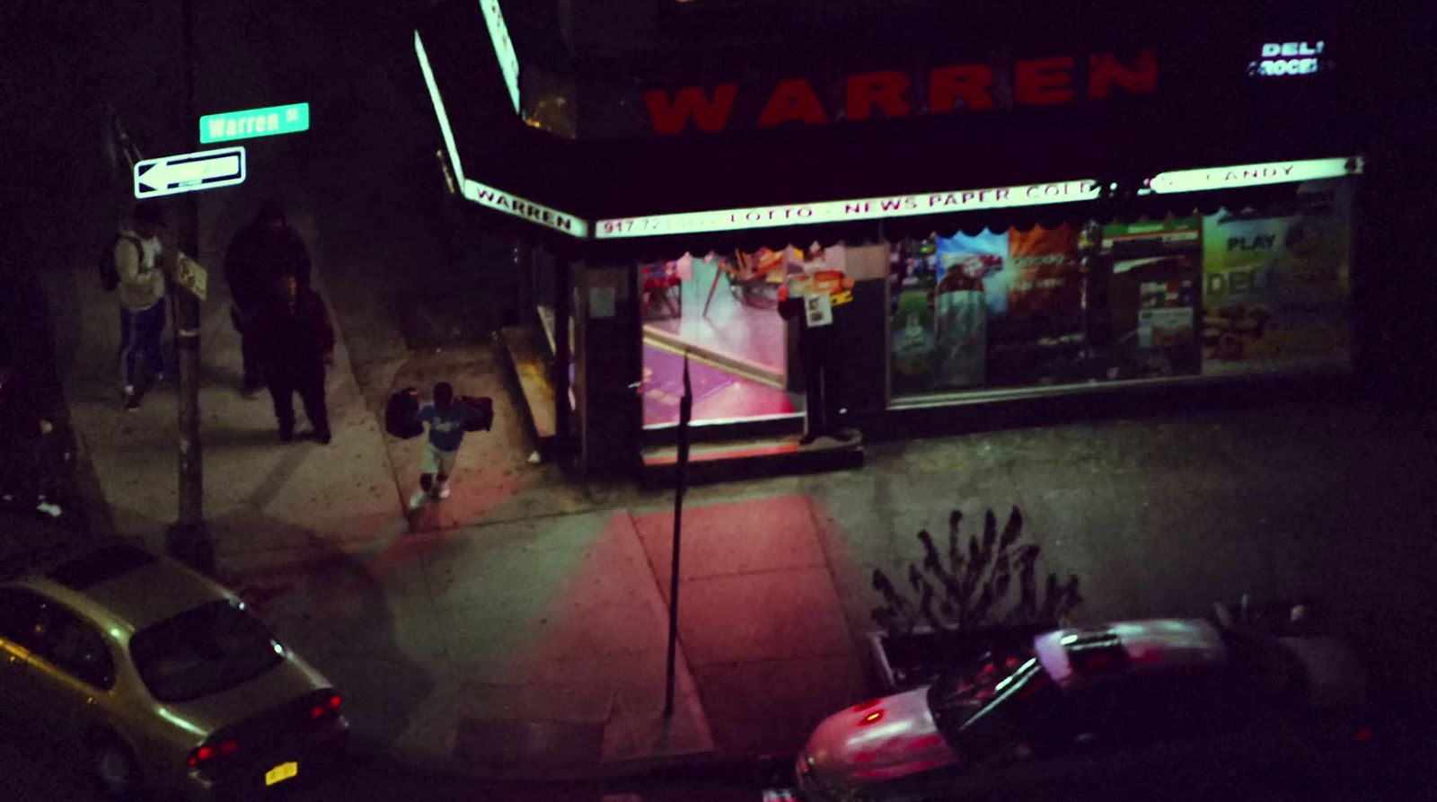 a dark city street at night with cars parked on the side of the street