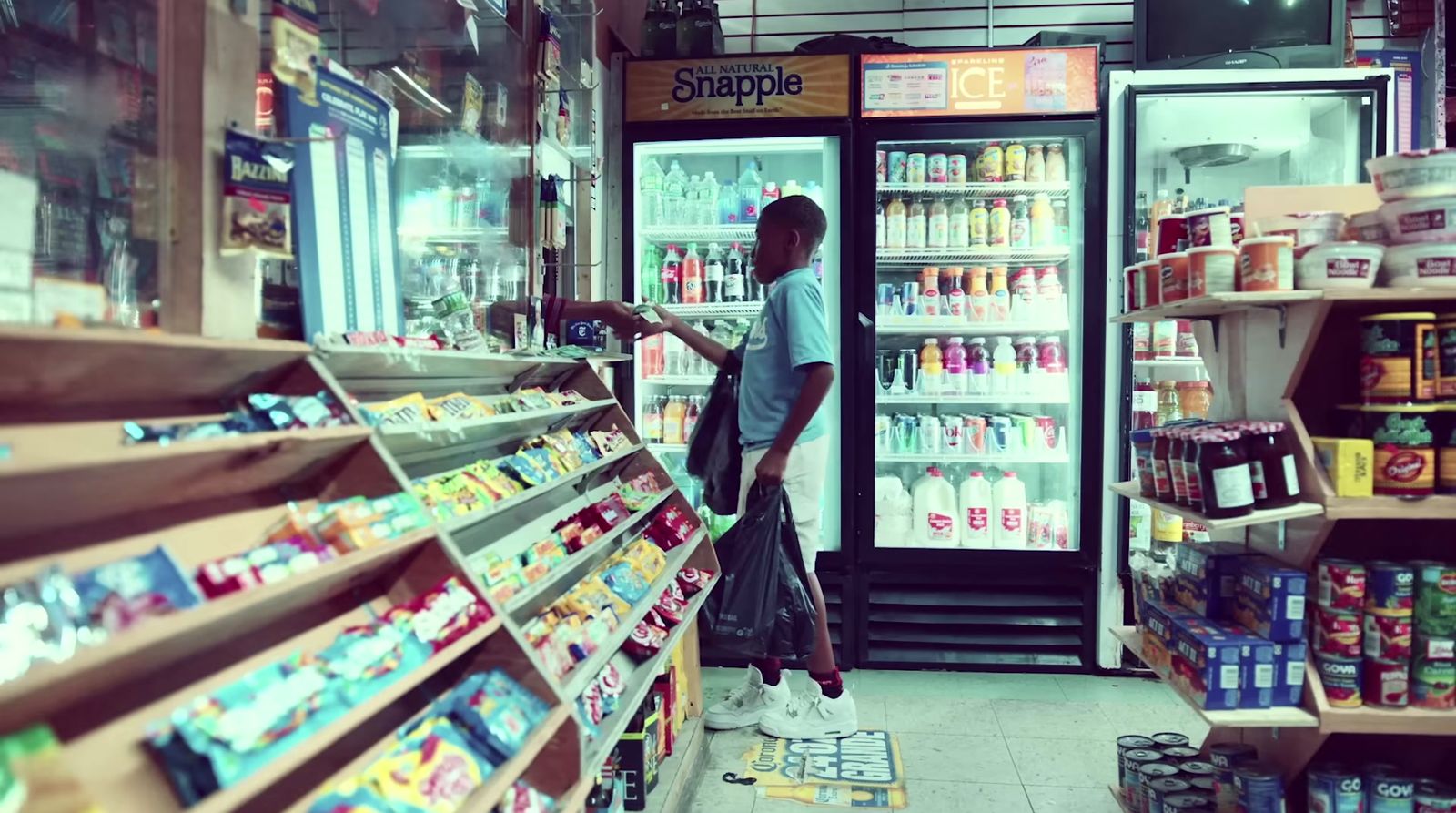 a man standing in front of a store filled with food