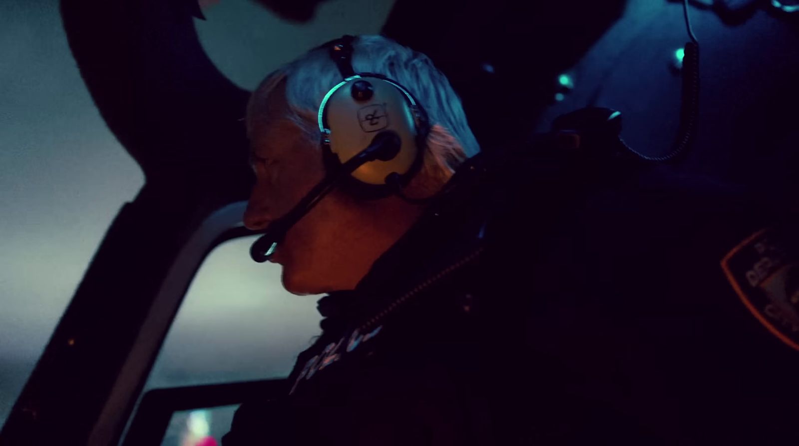 a man wearing a headset while sitting in a plane