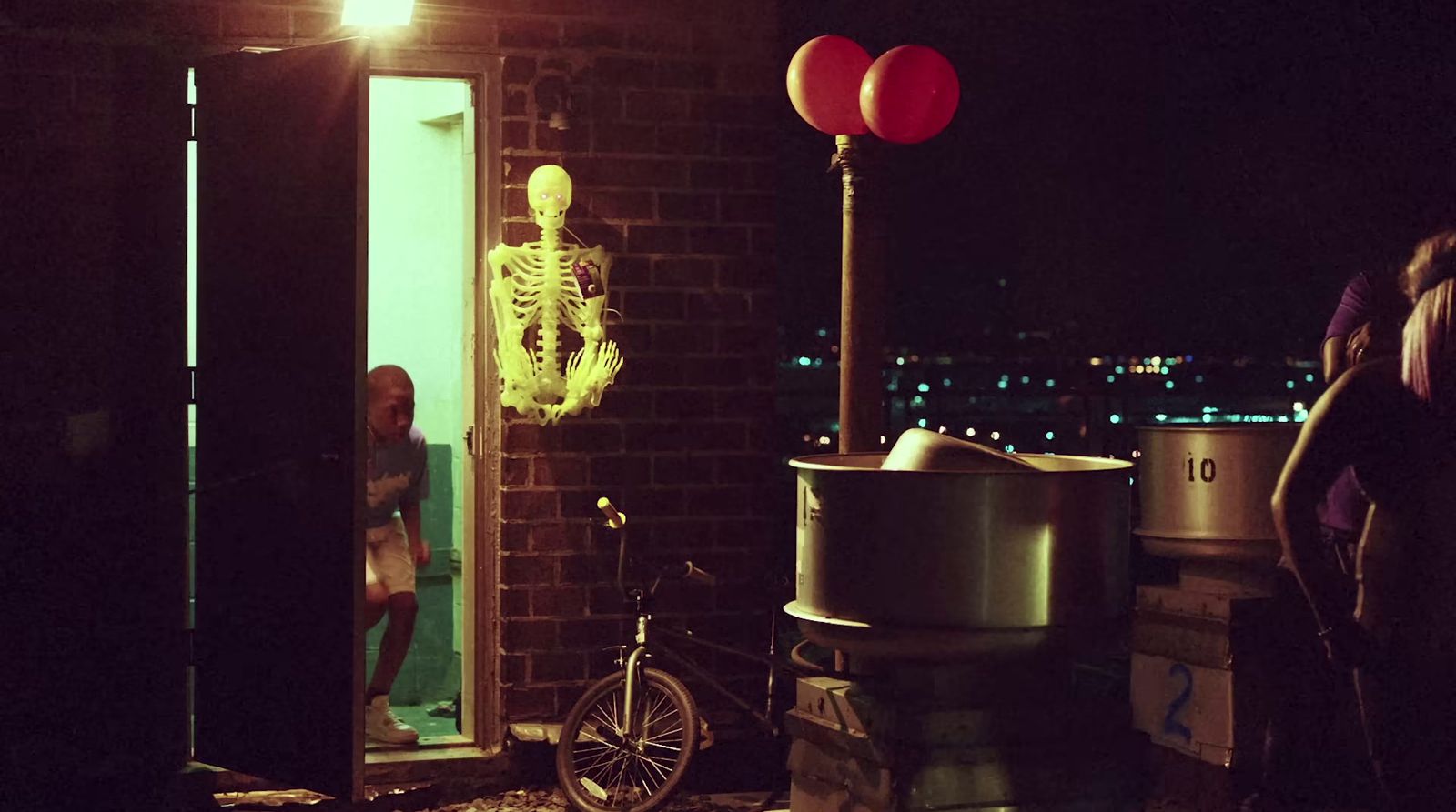 a skeleton in a room next to a bicycle