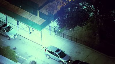 a car parked on the side of a road at night