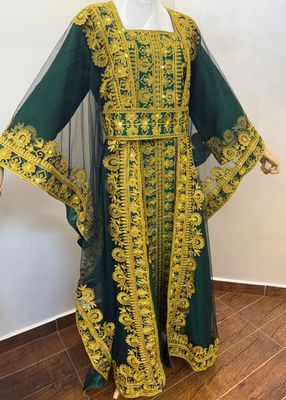 a mannequin wearing a green and yellow dress