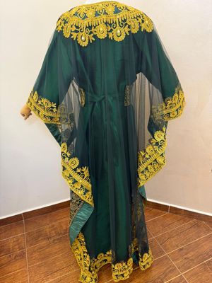a green and yellow dress on a mannequin