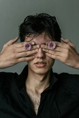 a man holding his hands over his eyes