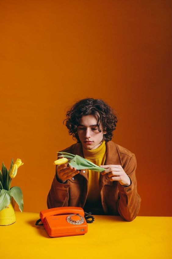 a man sitting at a table holding a piece of paper