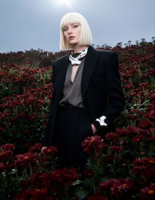 a woman standing in a field of flowers