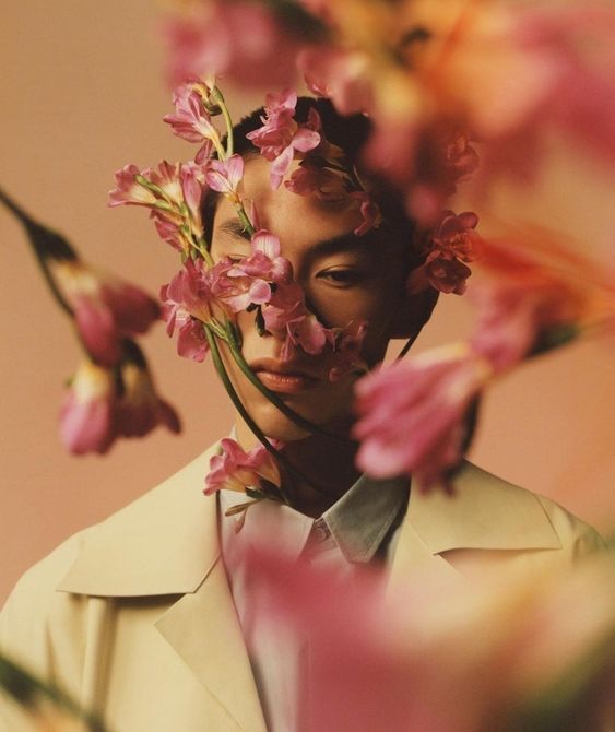 a man with flowers in his hair