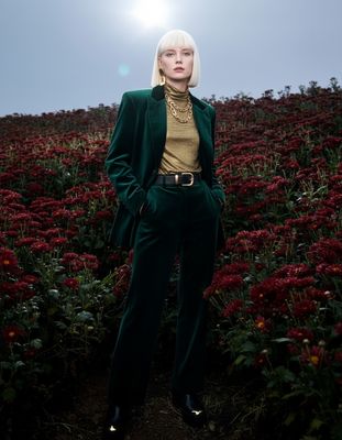 a woman standing in a field of flowers