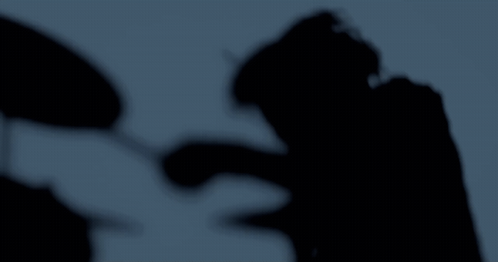 a shadow of a person holding an umbrella