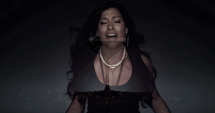a woman in a black dress with a necklace on