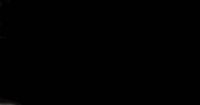a man in a suit and tie standing in front of a black background