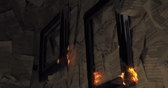 a fire burning through a window in a room