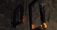 a fire burning through a window in a room