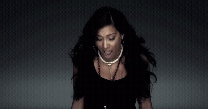 a woman in a black dress is making a face