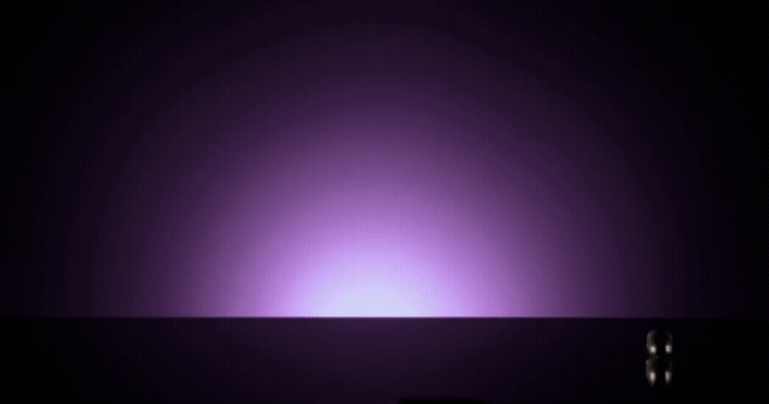 a dark room with a purple light in the middle