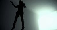 a silhouette of a woman jumping in the air