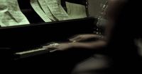a woman sitting at a piano with sheet music on it