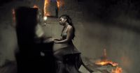 a woman sitting on a chair in a dark room