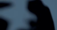 a blurry image of a person holding a cell phone