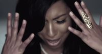a woman holding her hands up to her face