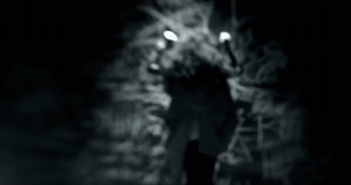 a man walking down a street at night