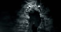 a man walking down a street at night