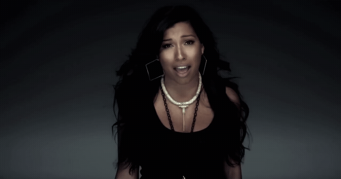 a woman in a black dress with a necklace on