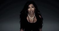 a woman in a black dress with a necklace on