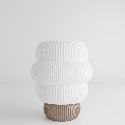 a white vase sitting on top of a table