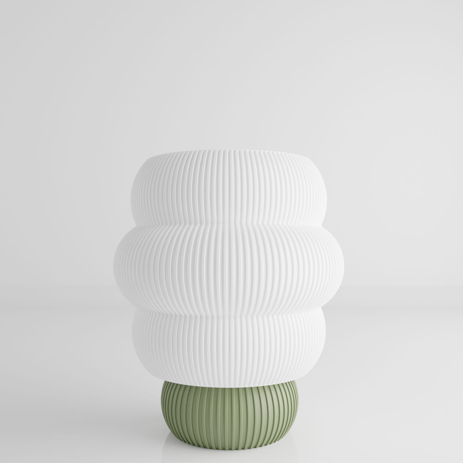 a white and green vase sitting on top of a table