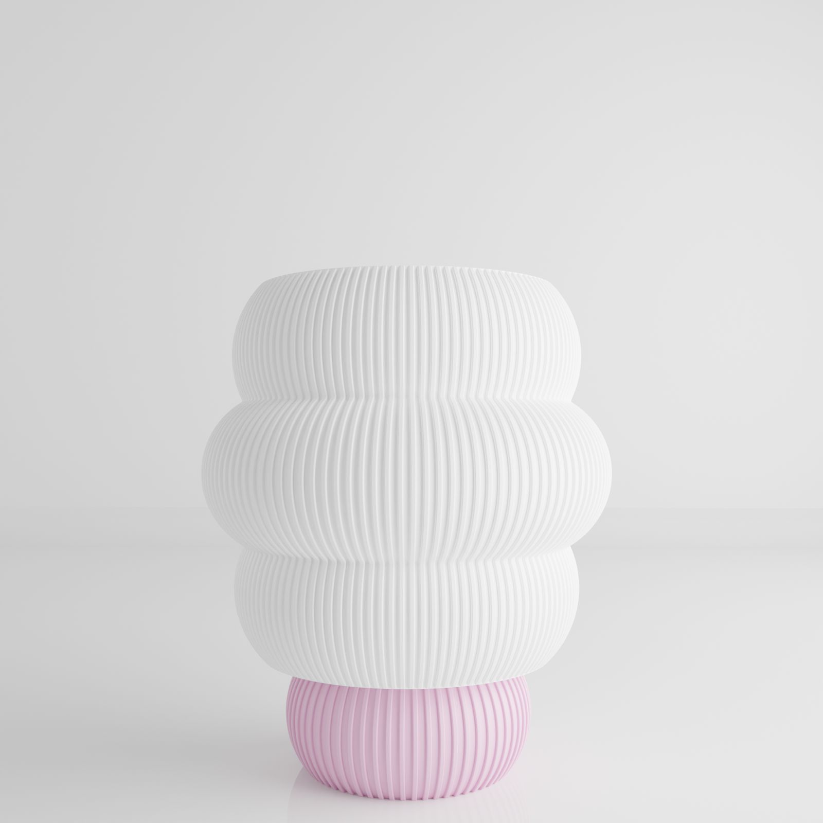 a white and pink vase sitting on top of a table
