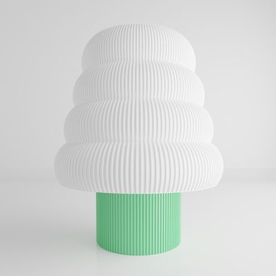 a white and green vase sitting on top of a table