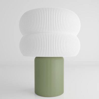 a green and white vase sitting on top of a table