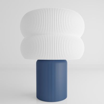 a blue and white vase sitting on top of a table
