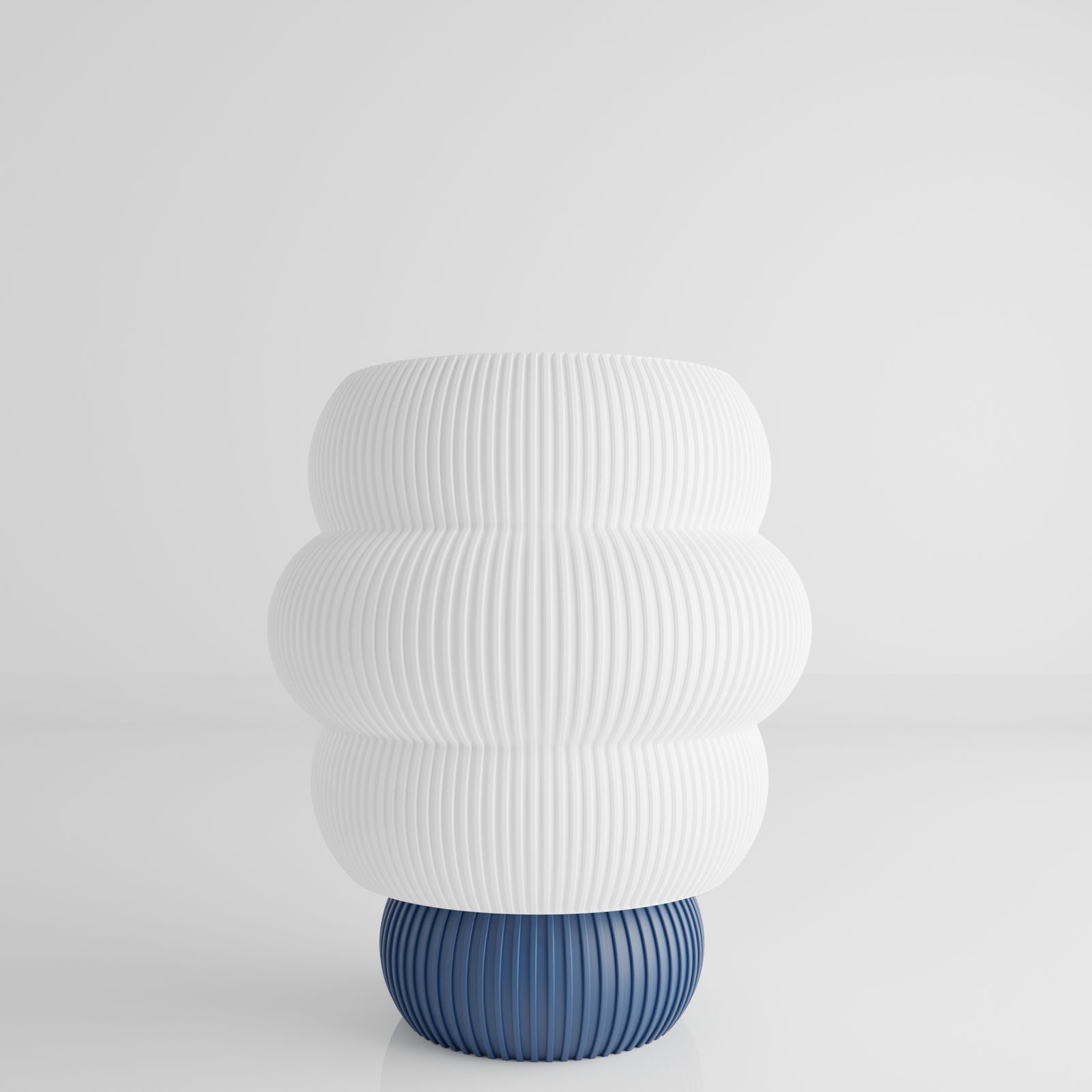 a white and blue vase sitting on top of a table