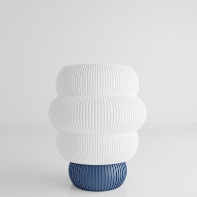 a white and blue vase sitting on top of a table