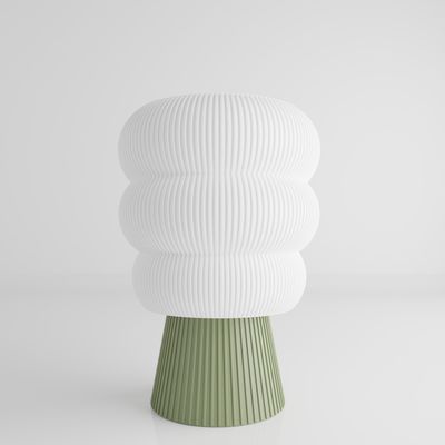 a white and green vase sitting on top of a table