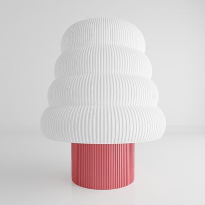 a white and pink vase sitting on top of a table