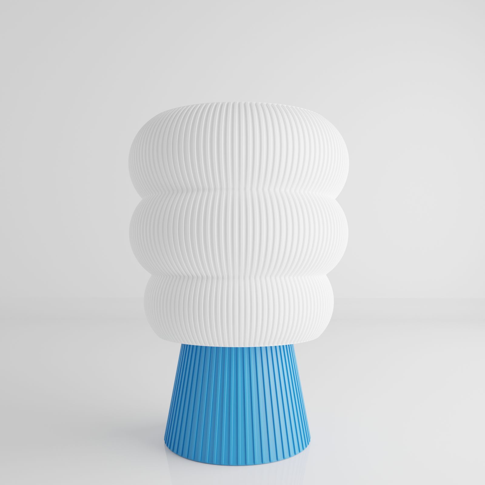 a white and blue vase sitting on top of a table