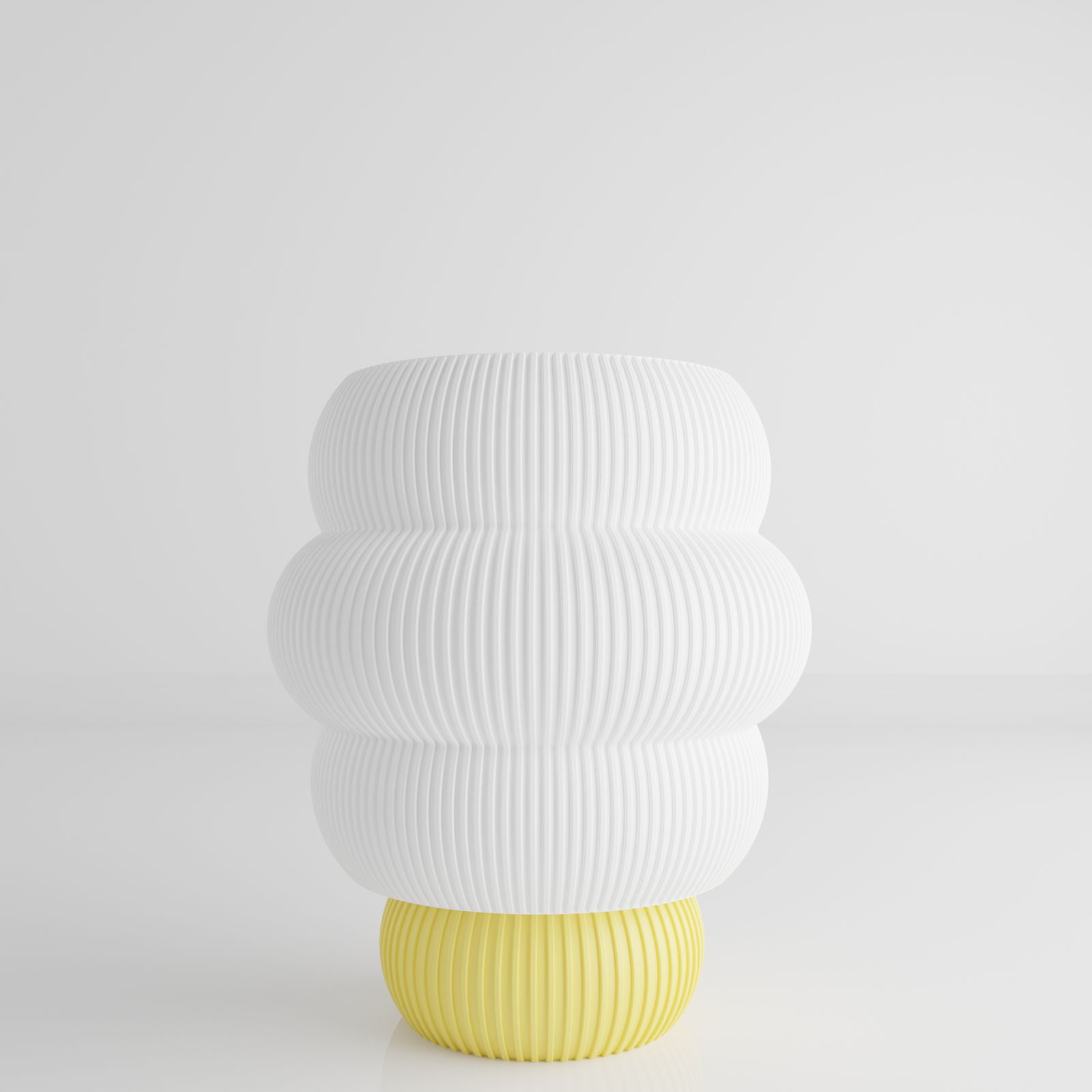 a white and yellow vase sitting on top of a table
