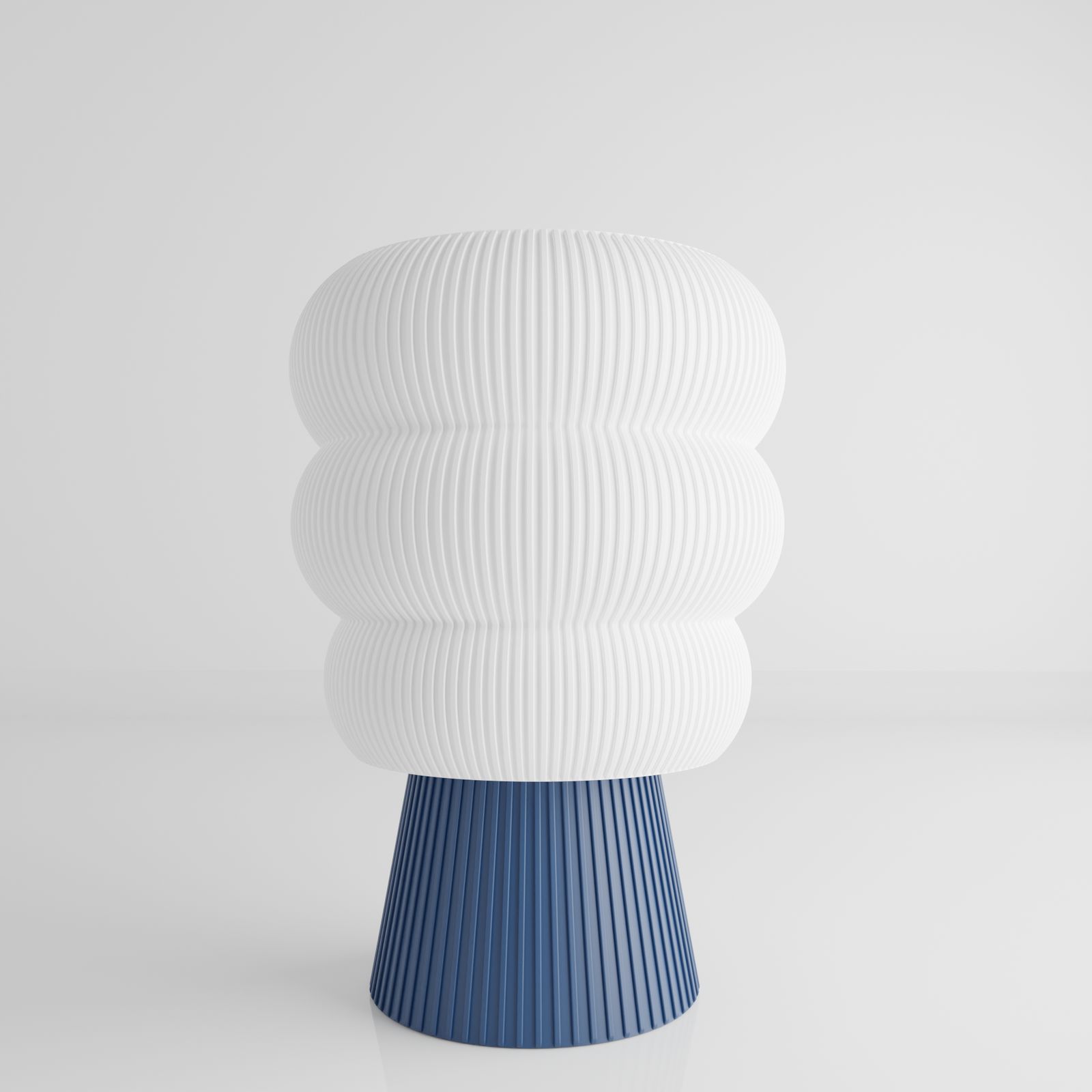a white and blue vase sitting on top of a table