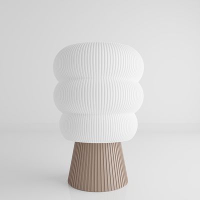 a white vase sitting on top of a table