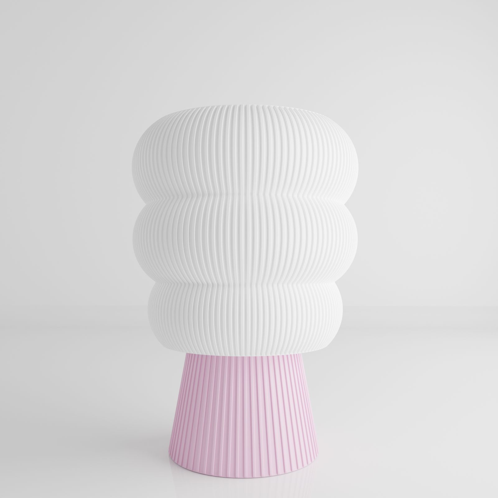 a white and pink vase sitting on top of a table