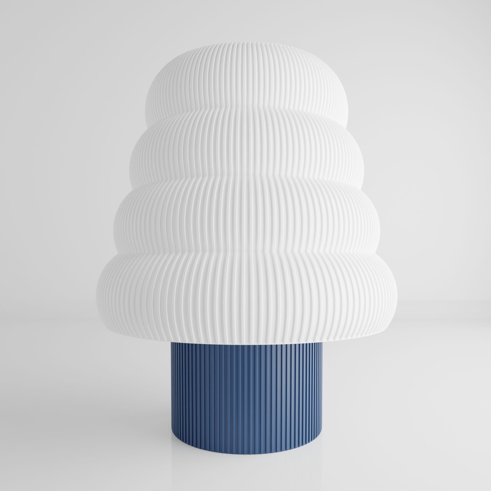 a white and blue vase sitting on top of a table