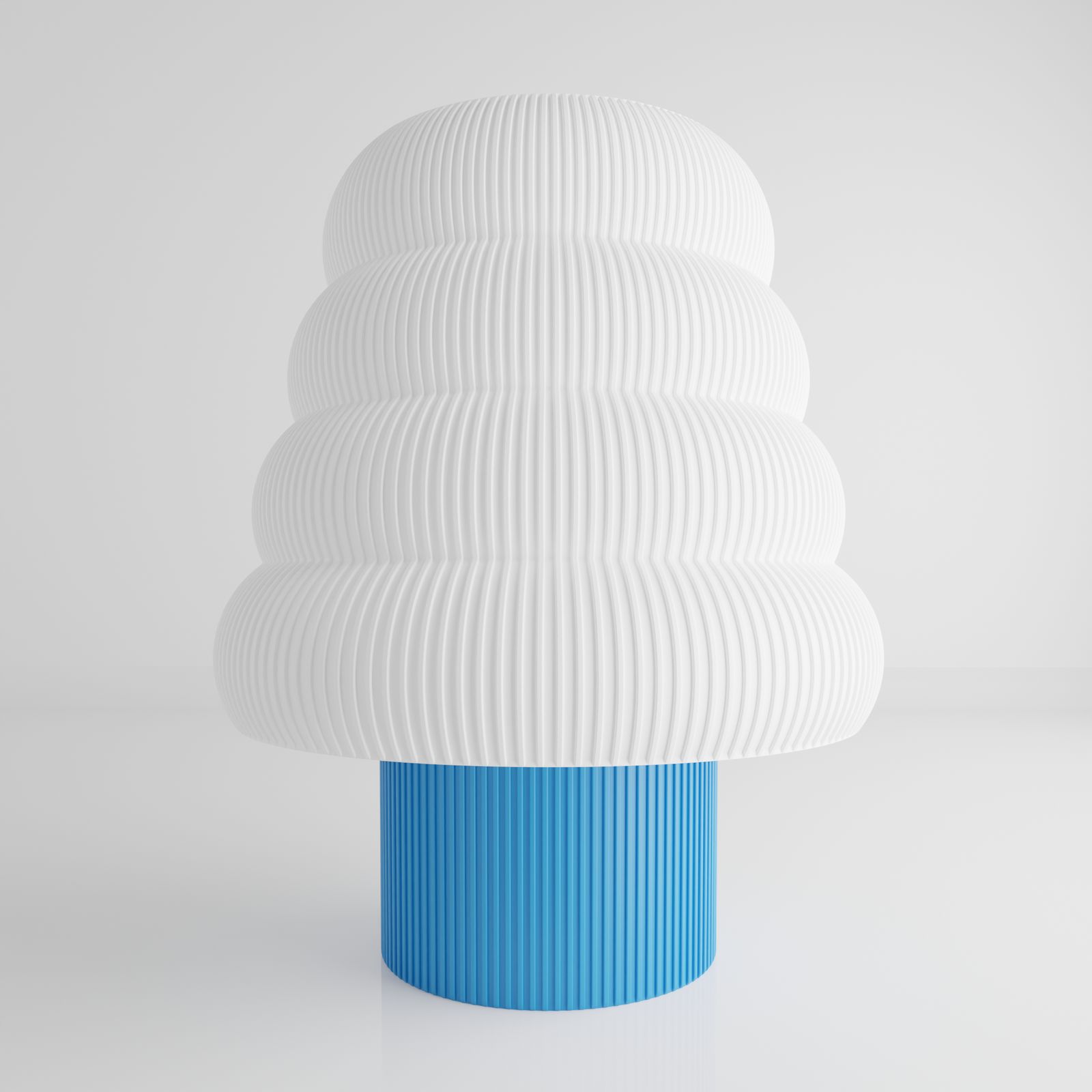 a white and blue vase sitting on top of a table