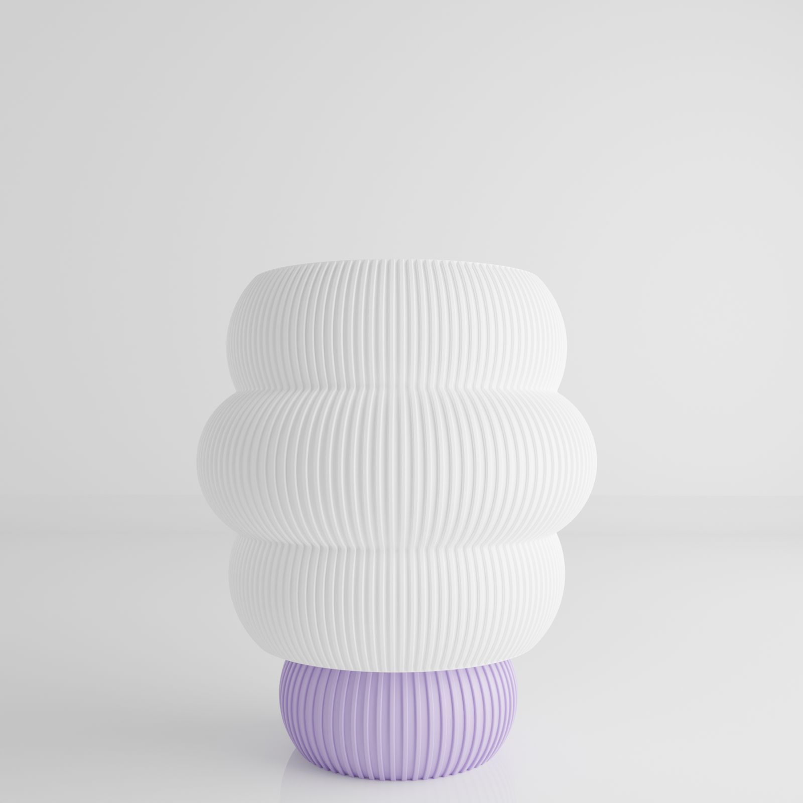 a white and purple vase sitting on top of a table