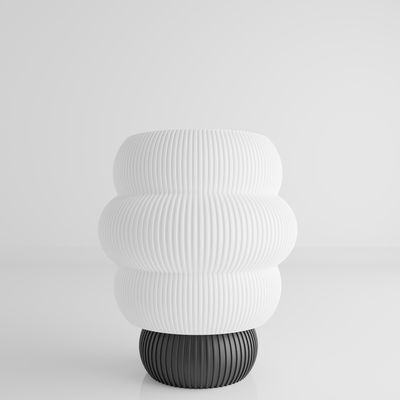 a white vase sitting on top of a table