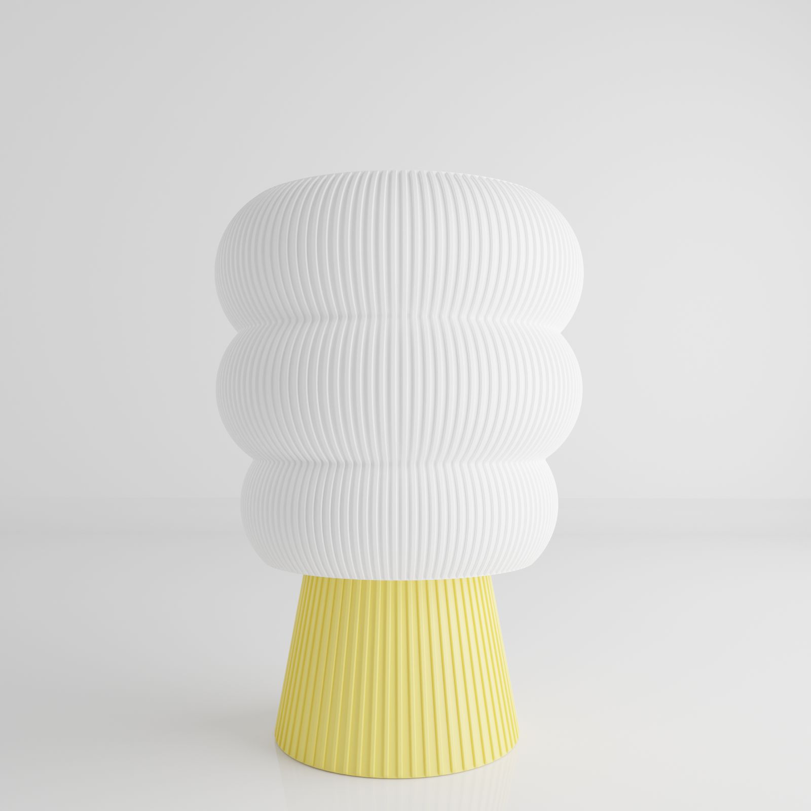 a white and yellow vase sitting on top of a table