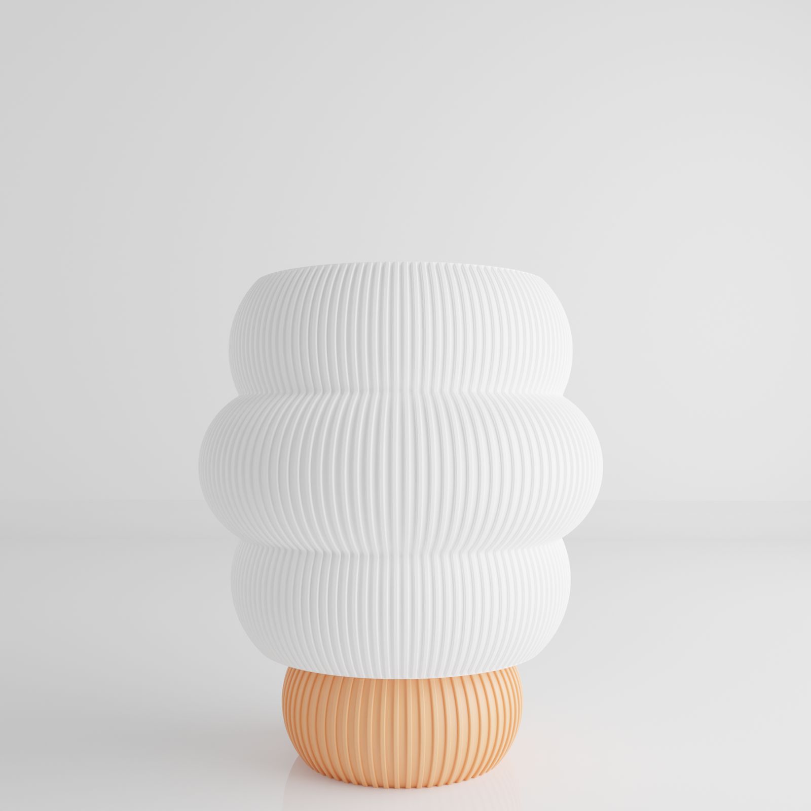 a white vase sitting on top of a white table