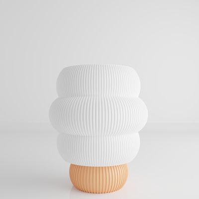 a white vase sitting on top of a white table